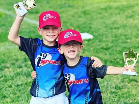 a couple of boys holding trophies