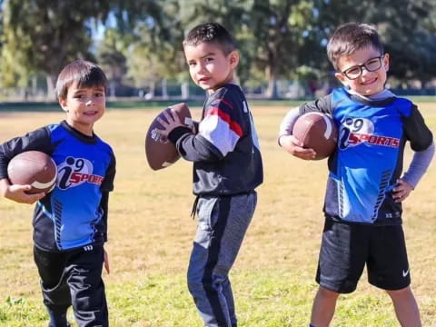 a group of boys holding footballs