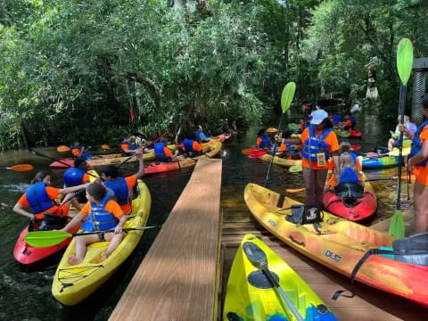 a group of people in kayaks