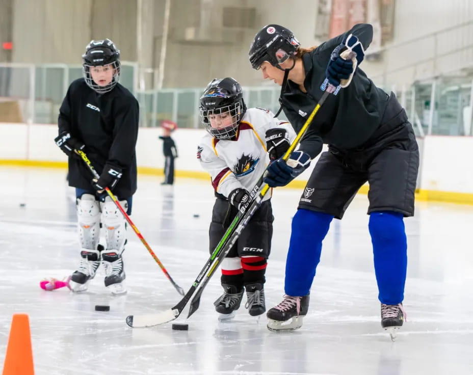 a group of people playing hockey