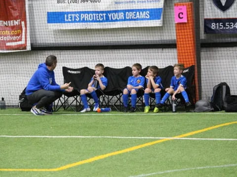 a group of boys sitting on chairs