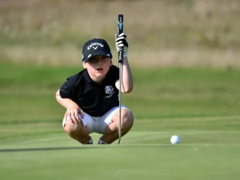 a boy playing golf