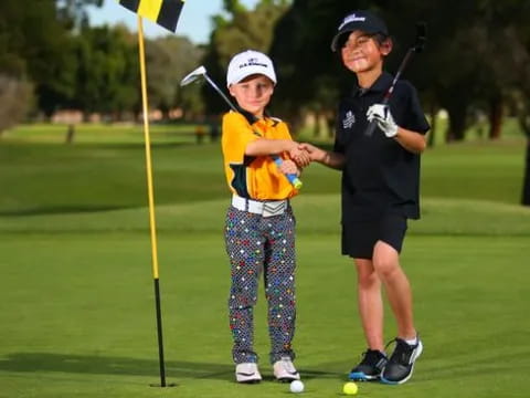 a person and a boy playing golf