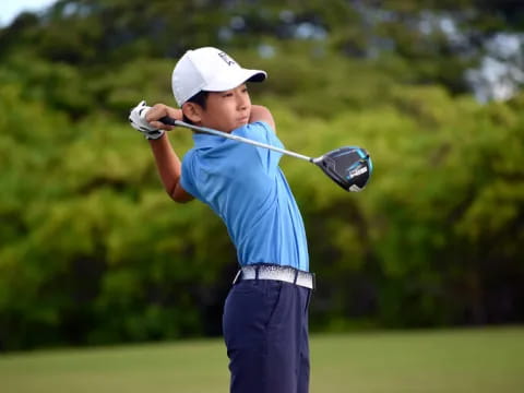 a person swinging a golf club