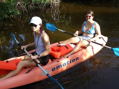 a couple of women in a canoe