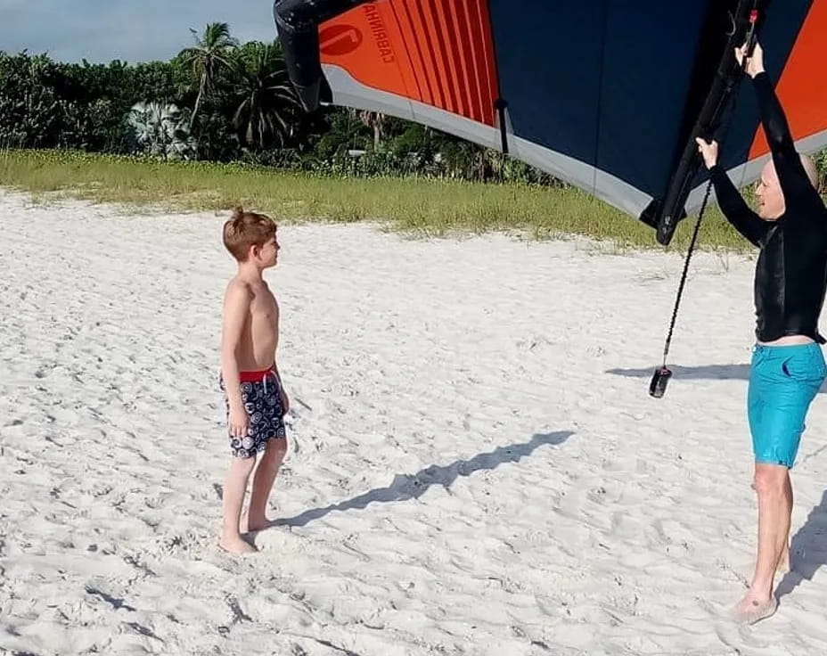 a person and a boy on a beach