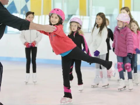 a group of people wearing ice skates and helmets