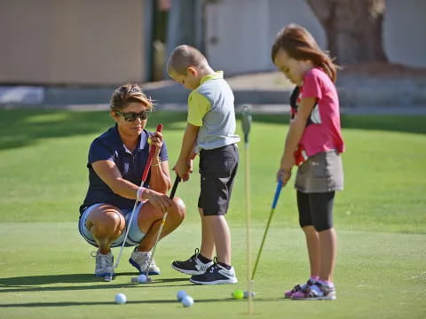 a group of kids playing golf