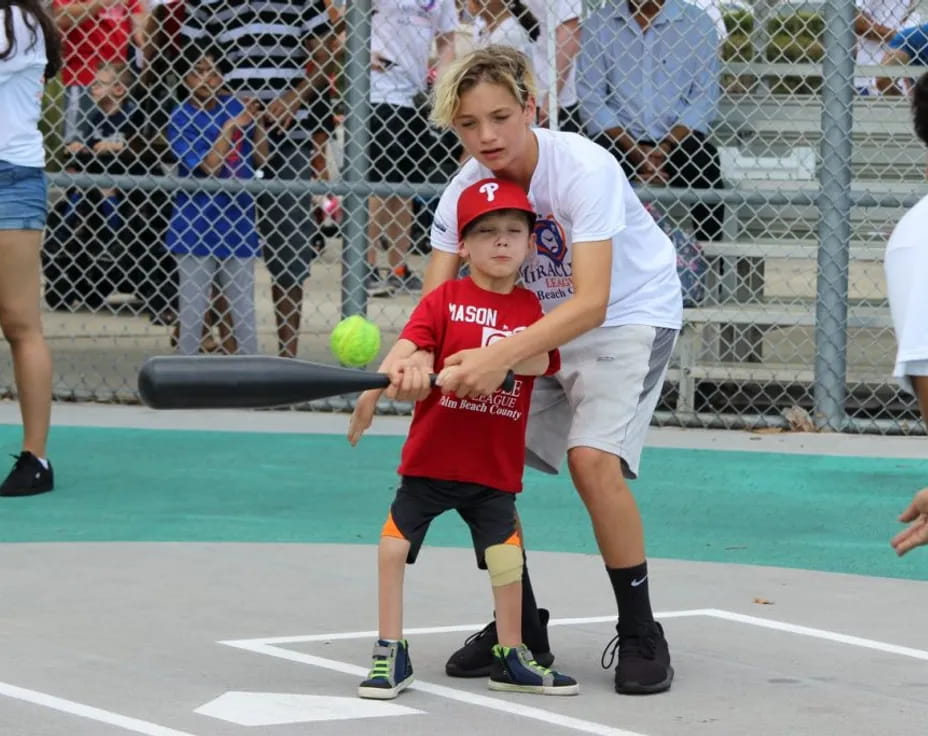 a person hitting a ball with a bat