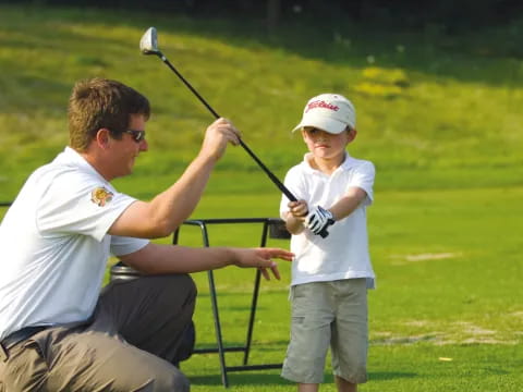 a man and a boy playing golf
