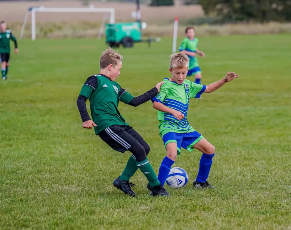 kids playing football on a field