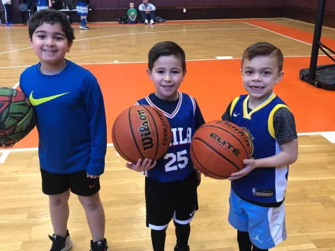 a group of boys holding basketballs