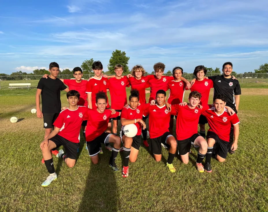 a group of people in red shirts