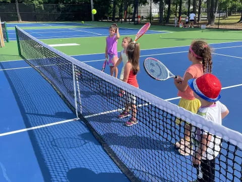 kids playing tennis on a court