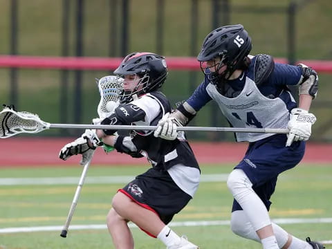 two men playing lacrosse