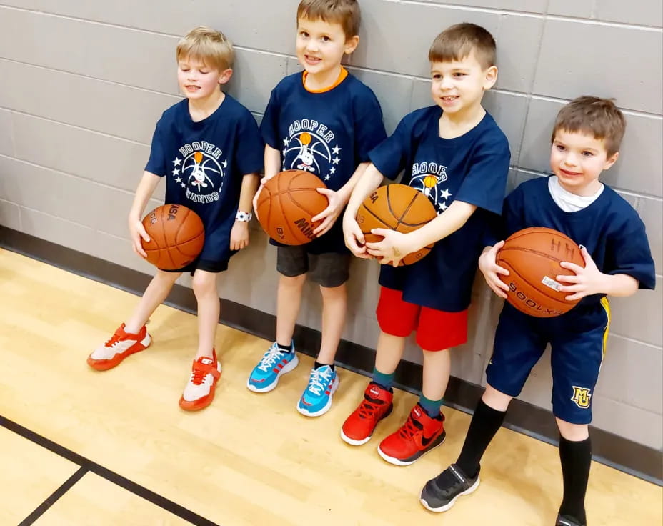 a group of boys holding basketballs