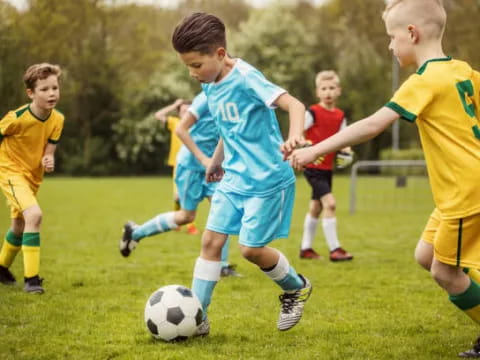 a group of kids playing football