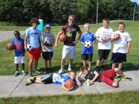 a group of people standing around a person lying on the ground