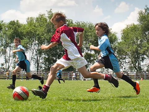 kids playing football on a field