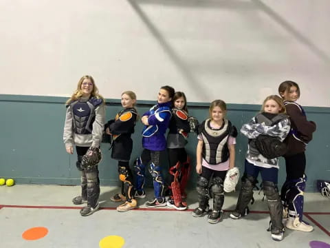 a group of people wearing ice skates posing for the camera