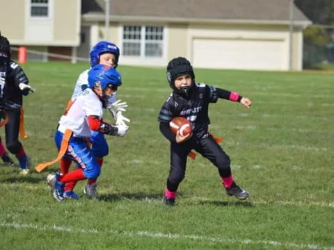 kids playing football on a field