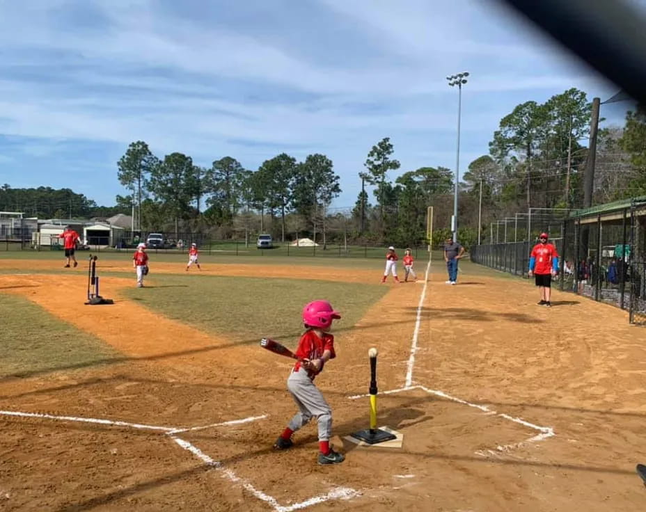 a kid swinging a baseball bat