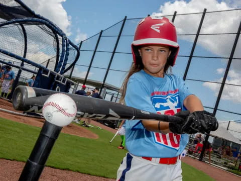 a young girl playing baseball