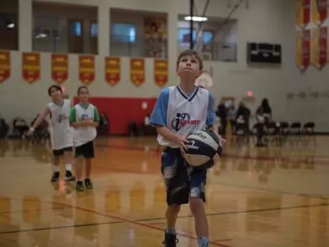 a boy holding a ball