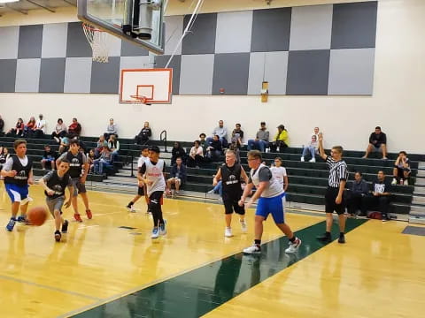 a group of people playing basketball