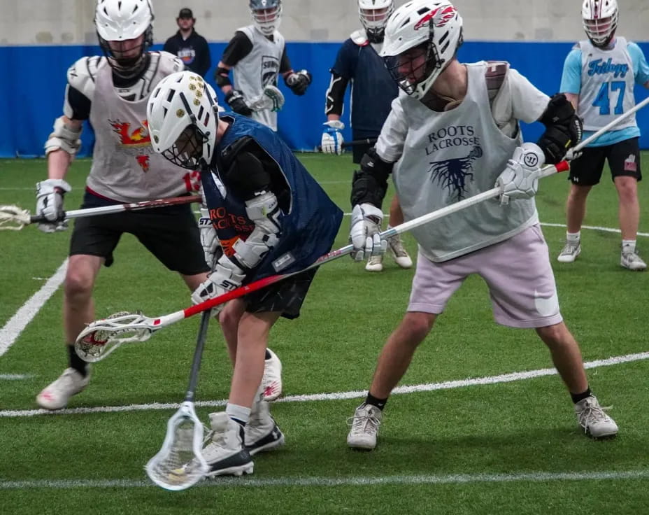 a group of men playing lacrosse