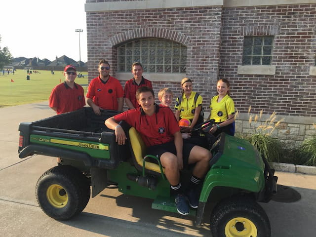 a group of people on a green vehicle