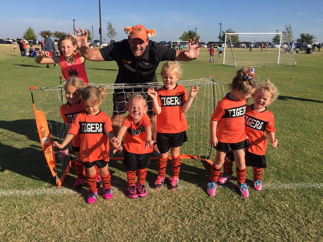 a person and a group of kids posing for a photo