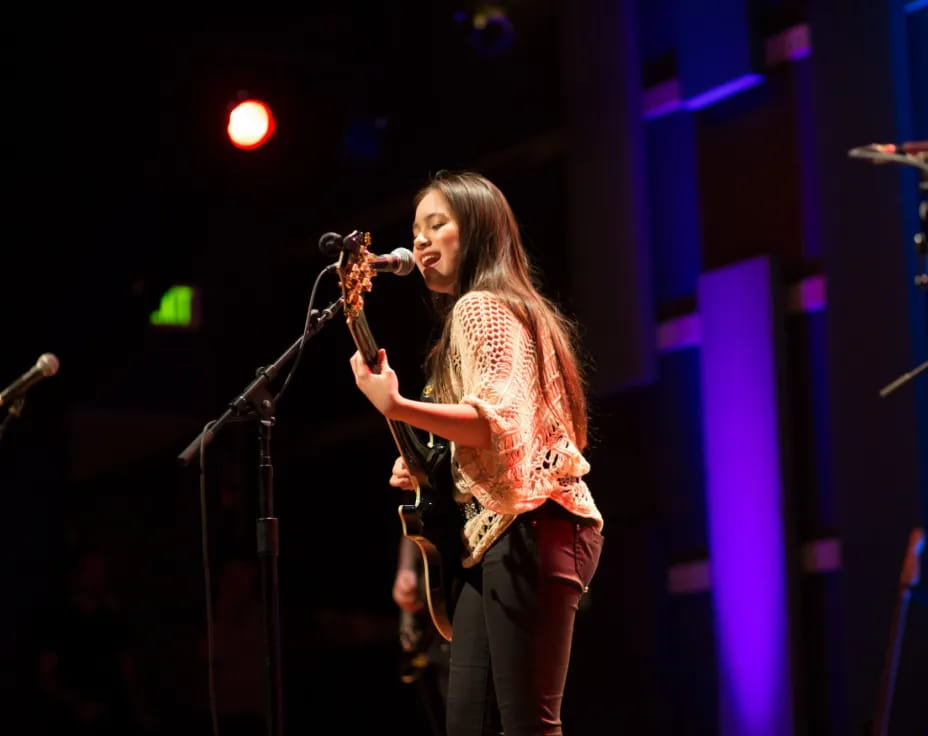 a person singing into a microphone