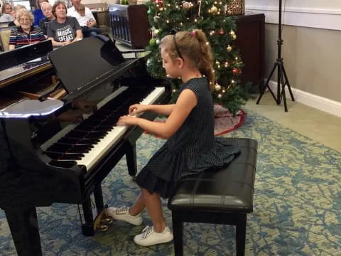 a girl playing a piano