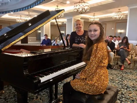 a person sitting at a piano