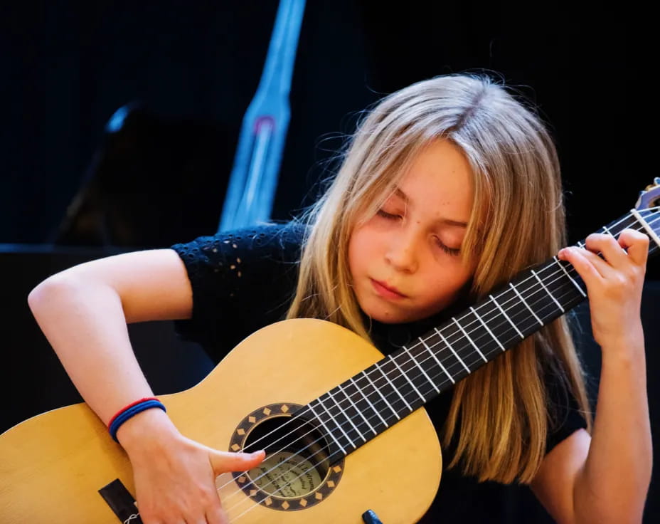 a woman playing a guitar