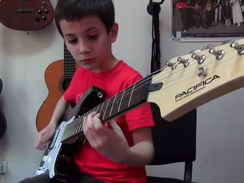 a boy holding a guitar