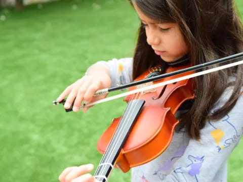 a girl playing a violin