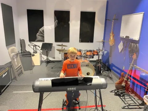 a boy playing a keyboard