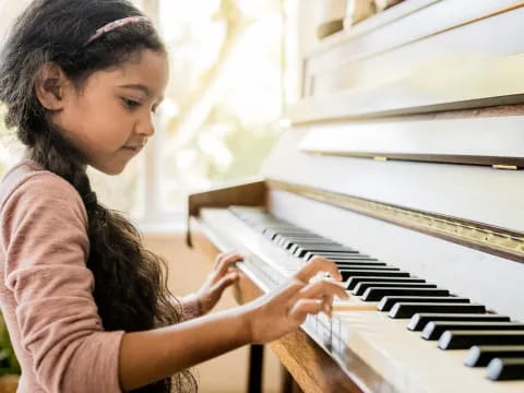 a girl playing a piano