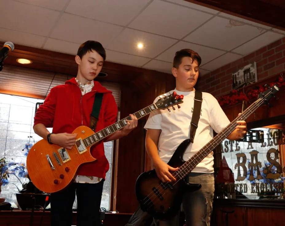 two men holding guitars