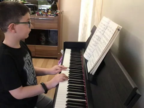 a boy playing a piano