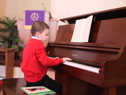 a boy playing a piano