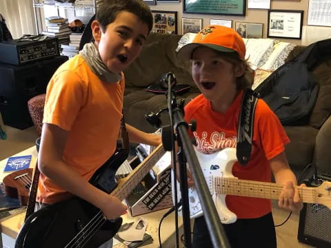 a couple of boys playing guitars