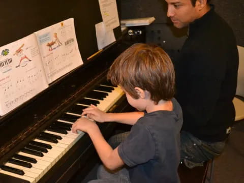a boy playing a piano