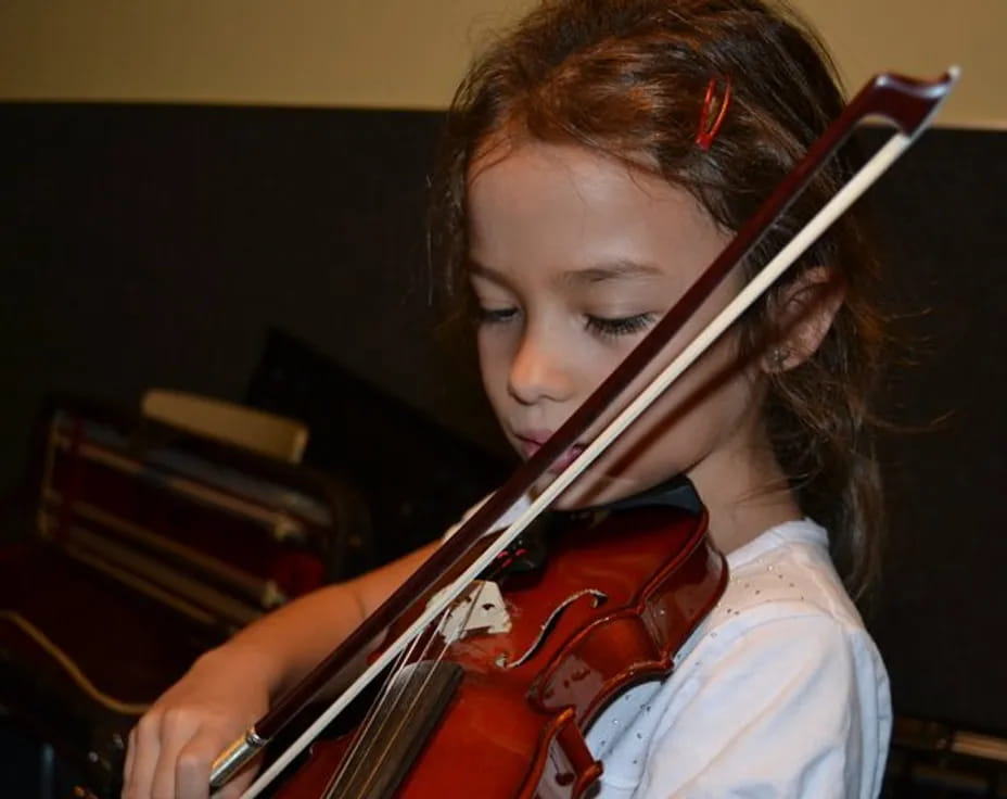 a girl playing a violin