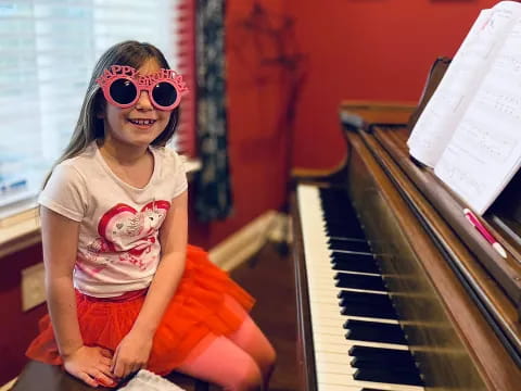 a person sitting on a piano