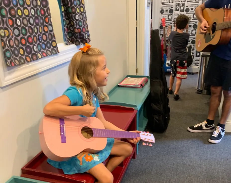 a girl sitting on a bench