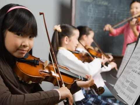 a group of kids playing violin