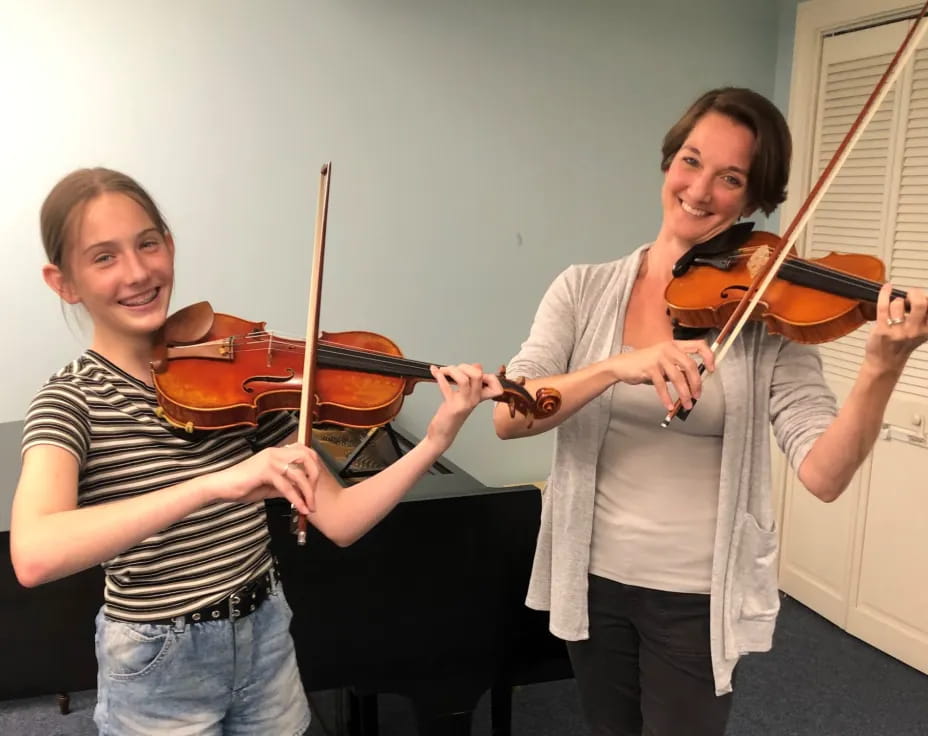 a couple of women playing violin